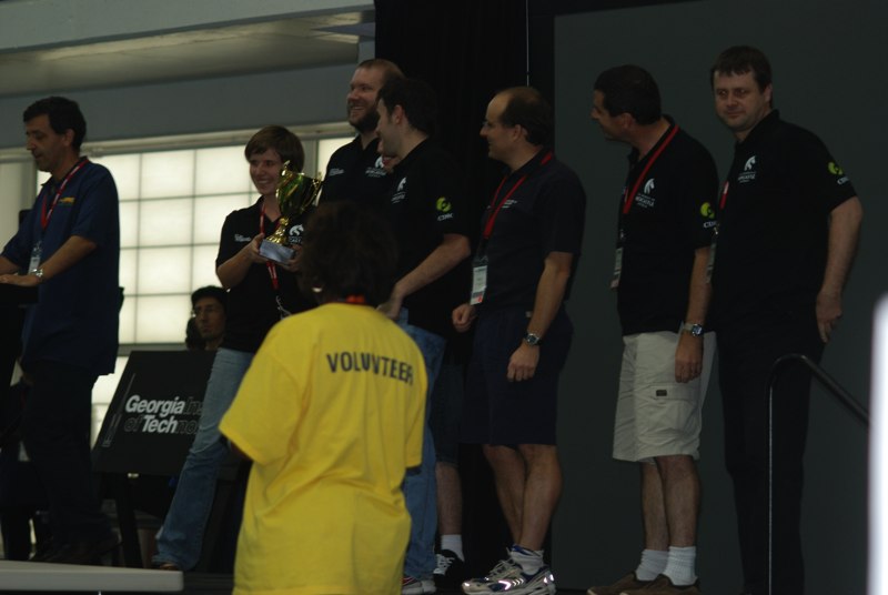 Members of the NUbots team on stage with their RoboCup 2007 runner-up trophy